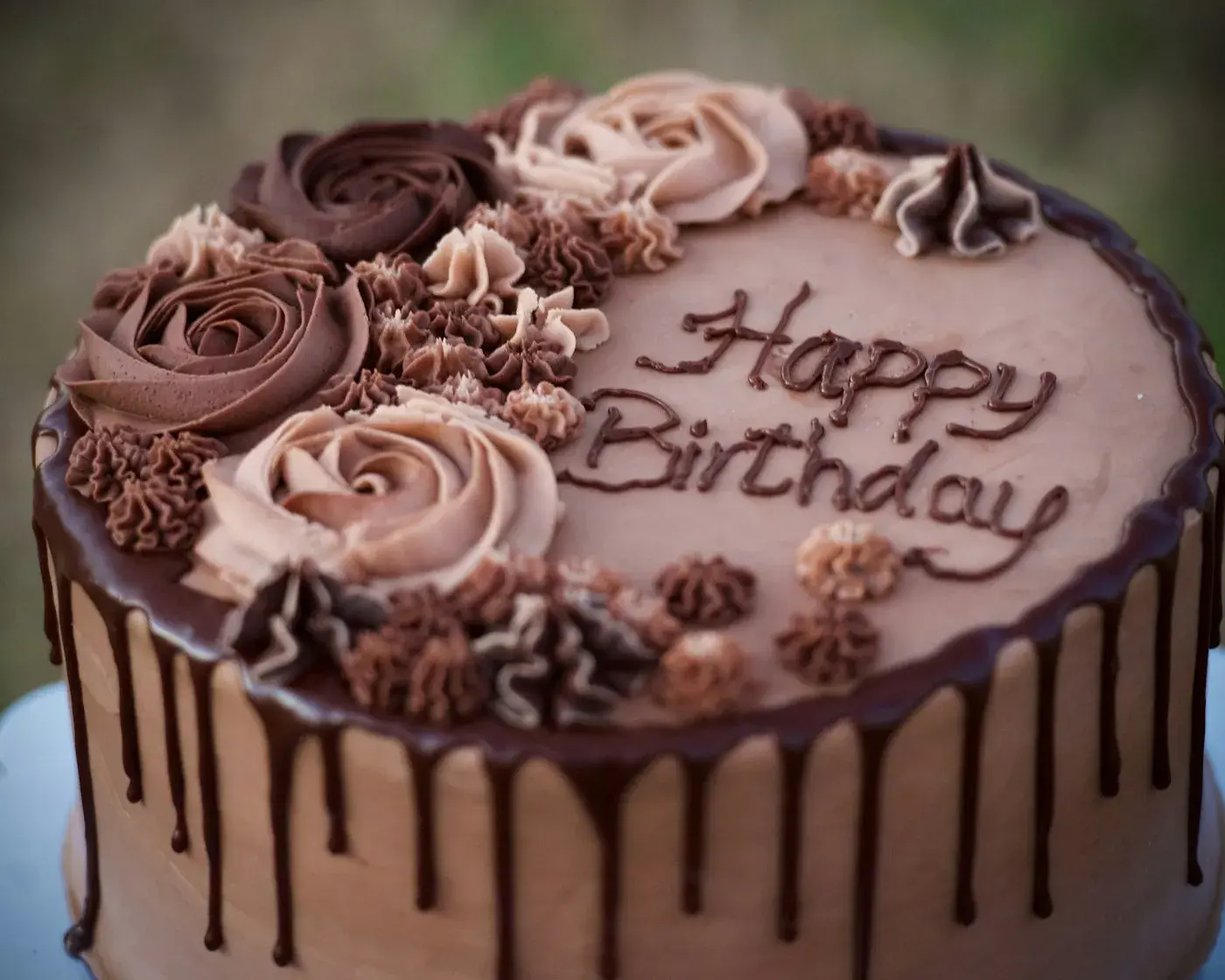 Chocolate happy-birthday cake with hand-piped roses