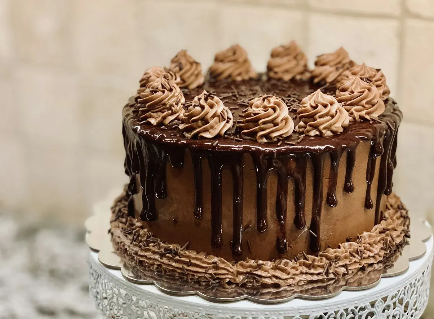 Chocolate drip cake with chocolate rosettes